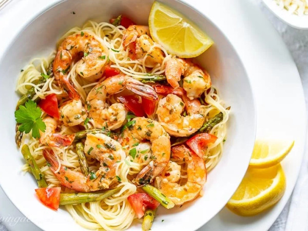 Shrimp Scampi Served with Tomatoes, Pasta, and Roasted Asparagus